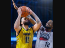 Sam Muldrow of the Windsor Express gets more nose than ball on Jermaine Haley of the London Lightning but it was enough to throw off the shot during their Basketball Super League game at Budweiser Gardens in London on Sunday March 3, 2024. Mike Hensen/The London Free Press