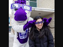 Western University mascot J.W. places special solar eclipse glass on the face of student Glenda Tsai in London on March 21, 2024. J.W. was handing out more than 1,000 pairs of the glasses to students and staff on Thursday. (Derek Ruttan/The London Free Press)