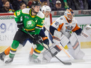 Max McCue of the London Knights and Gavin Ewles of the Flint Firebirds fight for position in front of Flint goalie Nathan Day during Game 1 of their Ontario Hockey League playoff series on Friday March 29, 2024. (Mike Hensen/The London Free Press)