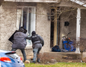 London Police officers throw a tear gas canister through the broken front window of a home at 48 Kinnear Cr. in London's Westmount neighbourhood, ending a six-hour standoff on March 19, 2024. (Mike Hensen/The London Free Press)