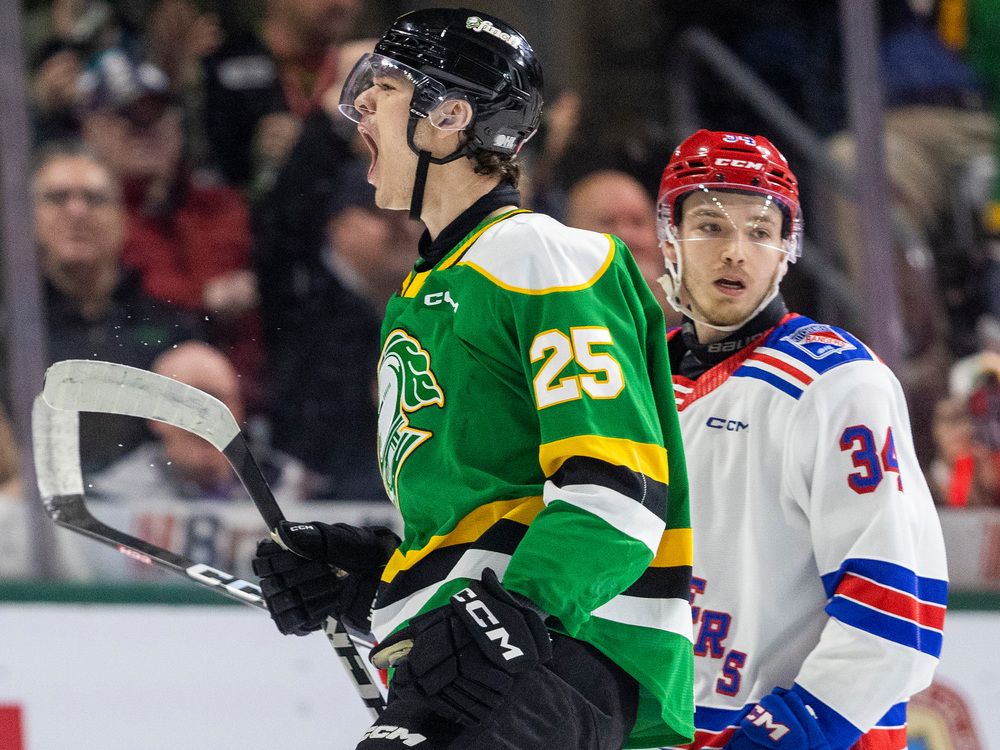 Kaleb Lawrence of the London Knights celebrates a goal as Olivier Savard of the Kitchener Rangers looks on during their Ontario Hockey League playoff game at Budweiser Gardens on April 11, 2024. (Mike Hensen/The London Free Press)