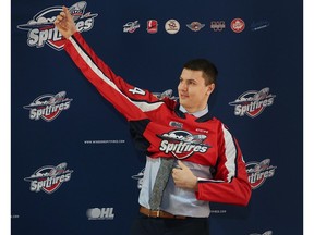 Forward Ethan Belchetz puts on a Windsor Spitfires jersey on Thursday after it was announced he will be the first overall pick in Friday's Ontario Hockey League Draft.