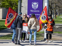 Striking graduate teaching assistants walk the picket line at the Richmond Street entrance to Western University in London on Monday, April 22, 2024. (Derek Ruttan/The London Free Press)