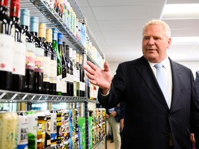 Ontario Premier Doug Ford gestures to a display of alcohol