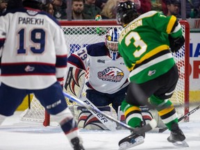 Sam Dickinson of the London Knights has perhaps the Knights' best scoring chance of the first period but is stopped point blank by Nolan Lalonde of the Saginaw Spirit as Zayne Parekh of the Spirit trails the play in Game 5 of Western Conference final at Budweiser Gardens in London on Friday, May 3, 2024.  (Mike Hensen/The London Free Press)
