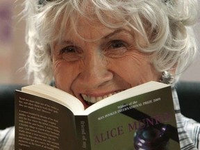 Author Alice Munro holds one of her books as she receives her Man Booker International award at Trinity College Dublin, in Dublin, Ireland, on June 25, 2009. Nobel Prize-winning Munro died on May 13 at the age of 92.
