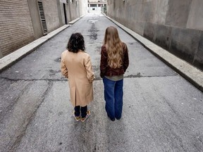 Two people standing in street