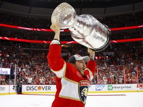 Brandon Montour of the Florida Panthers yells while lifting the Stanley Cup after Florida's 2-1 victory against the Edmonton Oilers in Game 7 of the 2024 Stanley Cup final at Amerant Bank Arena on June 24, 2024, in Sunrise, Fla. (Bruce Bennett/Getty Images)