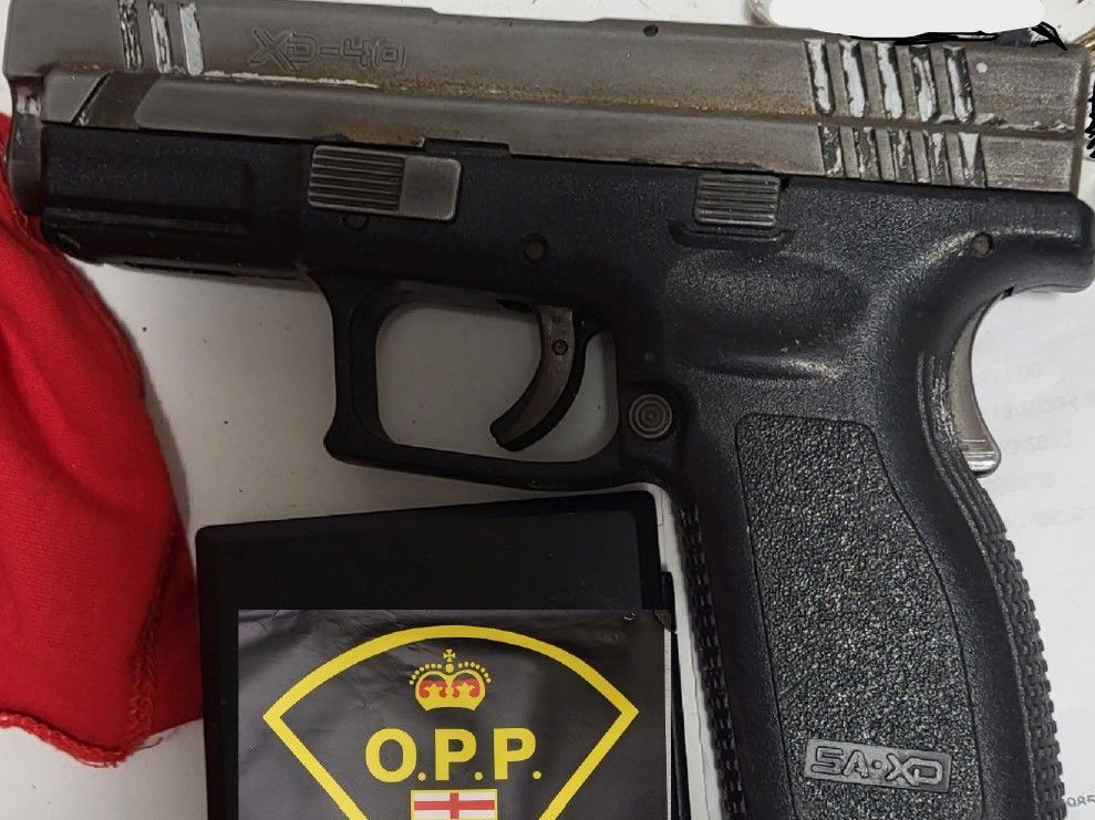 London police and the Ontario Provincial Police searched a home where investigators seized a handgun and nearly $20,000 worth of drugs on Tuesday, July 9, 2024. A man and woman, both 22, are charged with gun and drug offences. (OPP photo)
