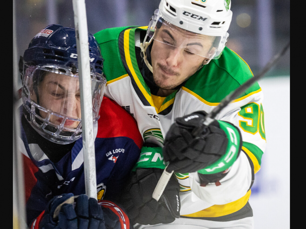 Landon Sim of the London Knights crushes the Saginaw Spirit’s Liam Storch against the boards in a game at Canada Life Place in London on Friday, Oct. 18, 2024. (Derek Ruttan/The London Free Press)