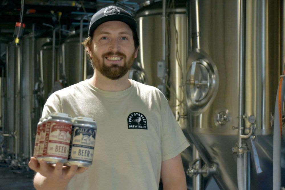 Brewer Ian McClure shows a six-pack of beers at the new Port Stanley Brewing. (Wayne Newton/Special to Postmedia News)