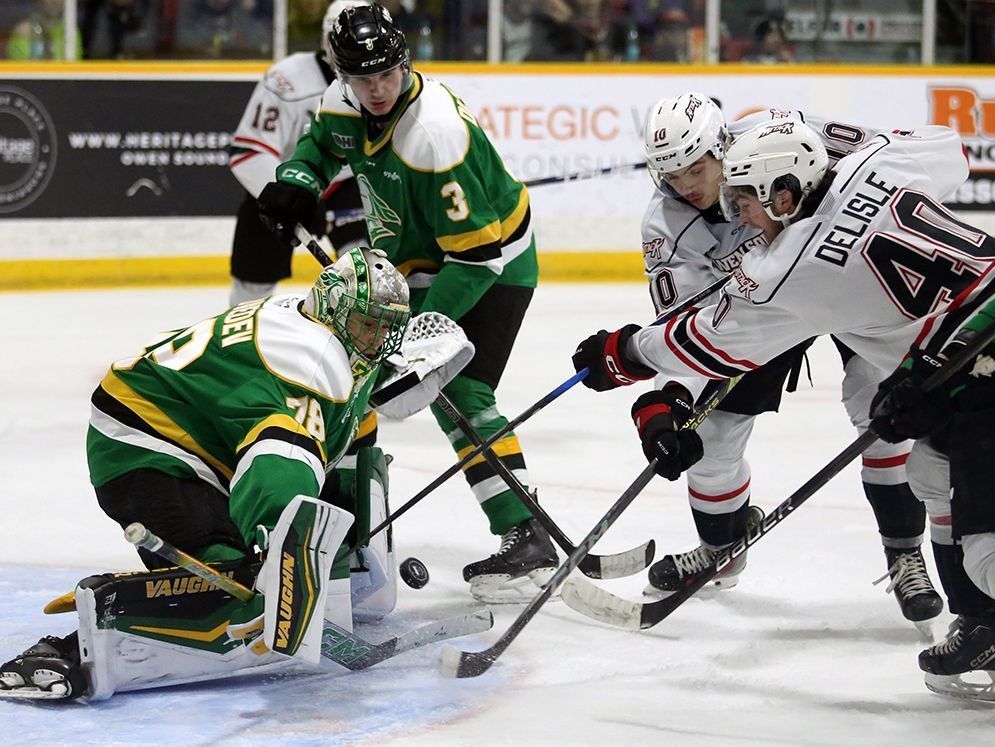 Landen Hookey and Tristan Delisle try to get their stick on the puck in front of goaltender Aleksei Medvedev as the Owen Sound Attack and London Knights play inside the Harry Lumley Bayshore Community Centre on Sunday, Nov. 3, 2024. Greg Cowan/The Sun Times