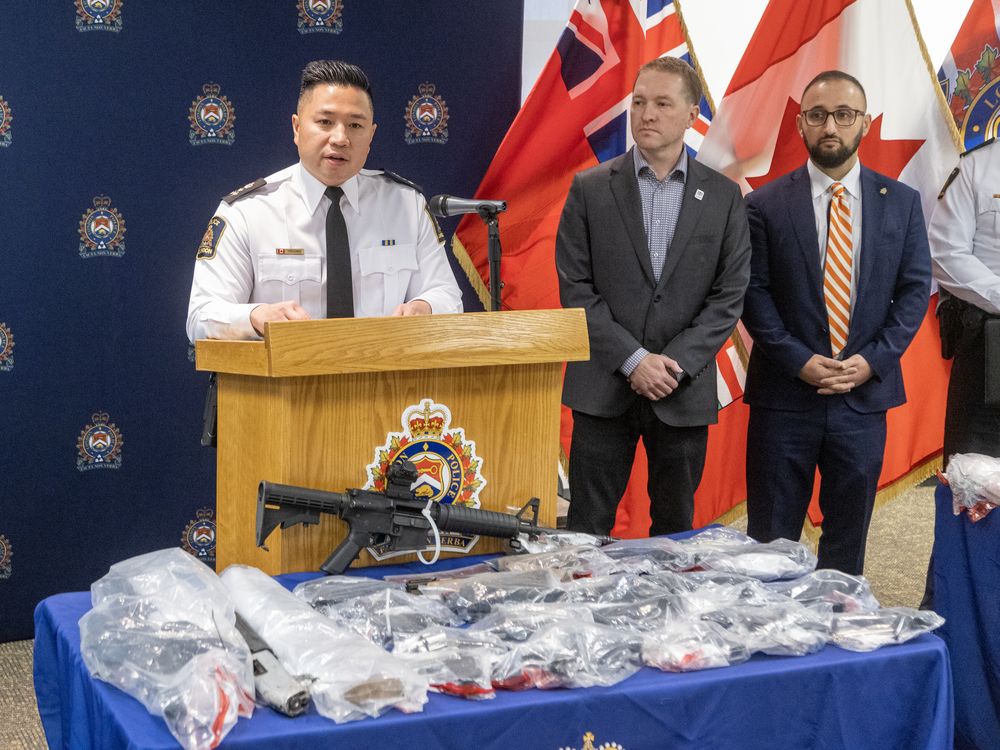 With London Mayor Josh Morgan and police services board chair Ali Chahbar at his side, London police Chief Thai Truong announces police have seized 19 guns and drugs valued at $8.4 million since July at a news conference at police headquarters on Wednesday, Dec. 18, 2024. (Derek Ruttan/The London Free Press)