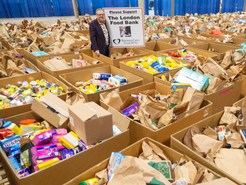 Wayne Dunn stands with some of the food donated to the Business Cares Food Drive. Photo taken on Dec. 9, 2024. (Mike Hensen/The London Free Press)