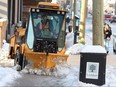 snowplow clears the sidewalk
