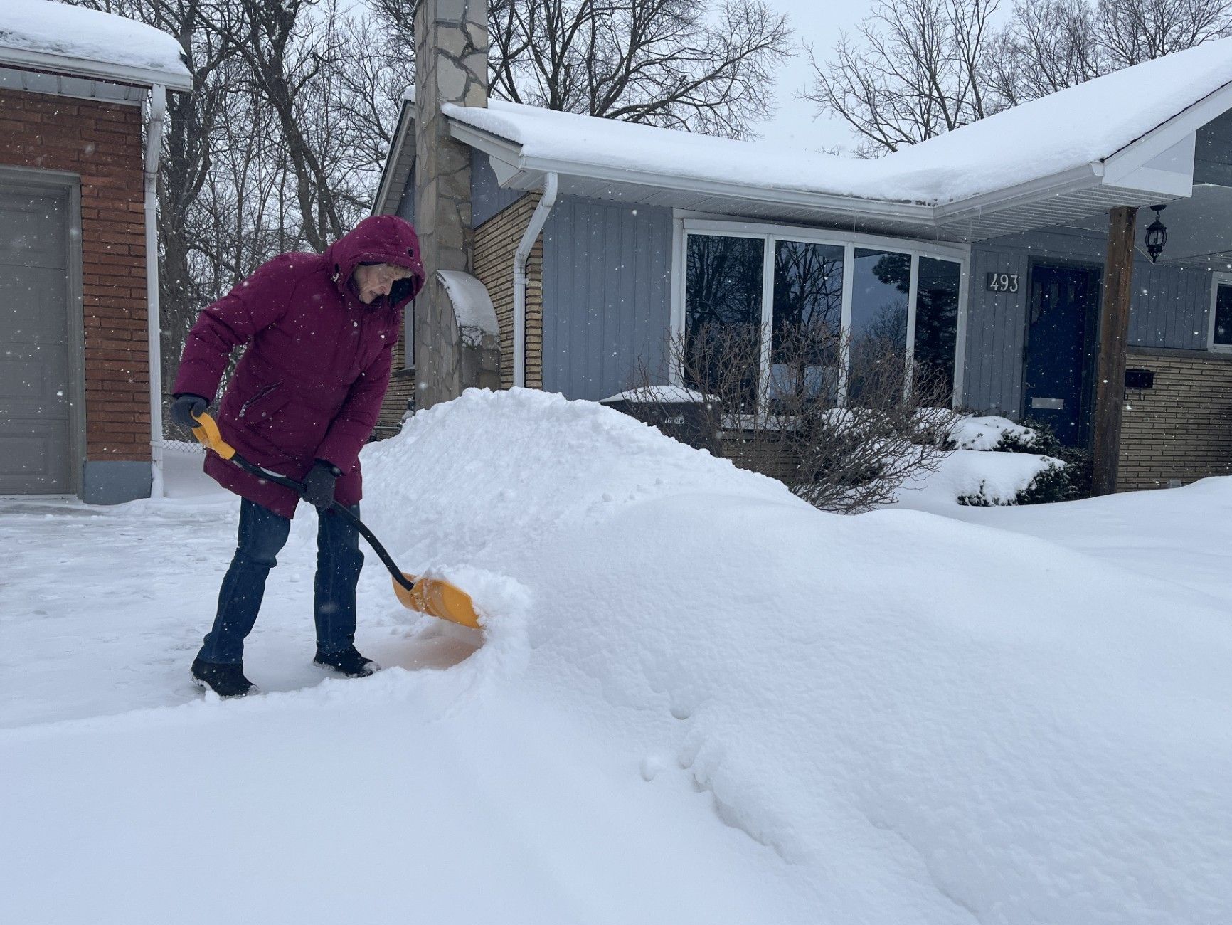 Karen Hirschleber shovels out her driveway in London on Saturday February 15, 2025.. (Jennifer Bieman/The London Free Press) 