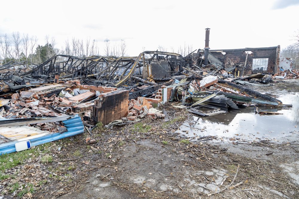 Firefighters were still on the scene one day after a blaze at a vacant warehouse at 100 Woodworth Ave. in St. Thomas. Photo shot on Tuesday April 15, 2025. (Derek Ruttan/The London Free Press)
