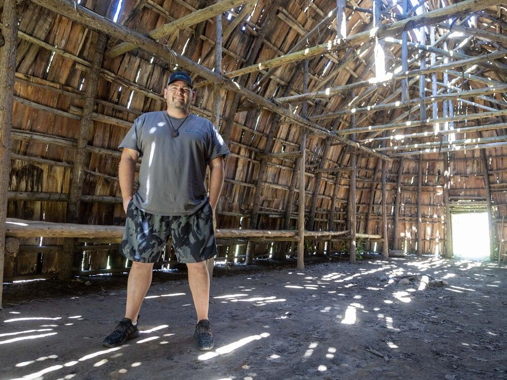Indigenous community educator Tyler French stands inside one of the three longhouses at Ska-Nah-Doht Village at Longwoods Conservation Area in Mt. Brydges. (Derek Ruttan/The London Free Press)