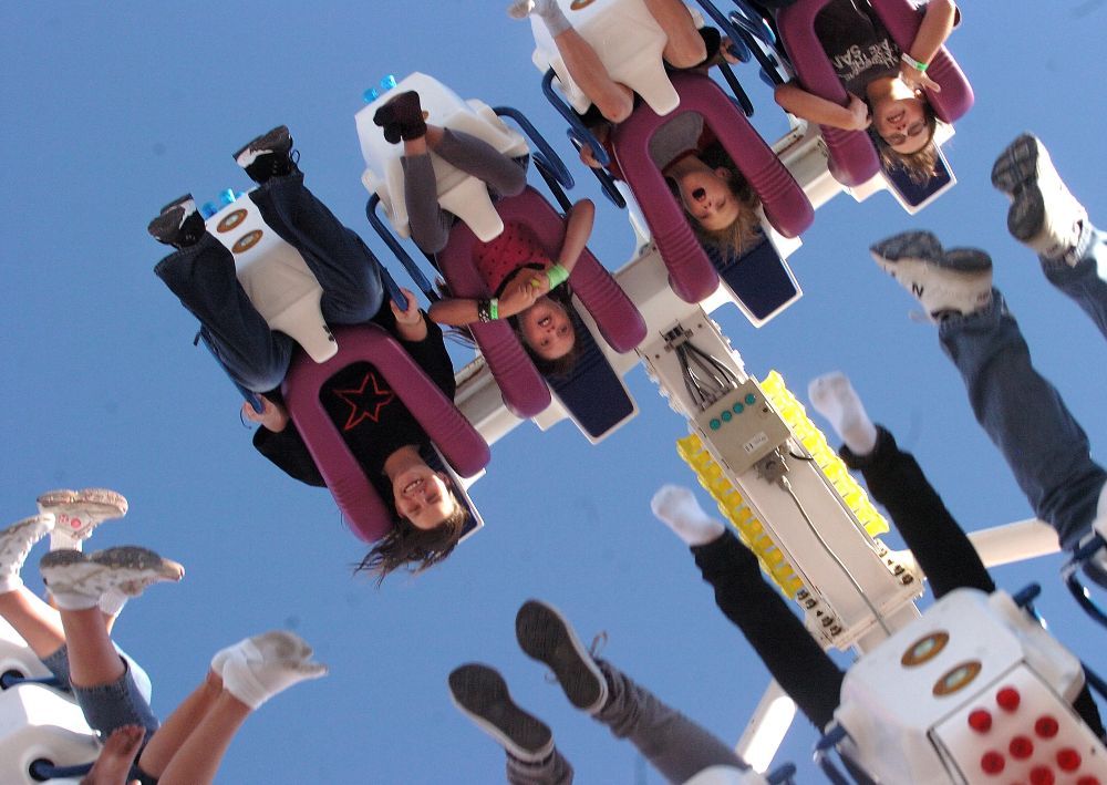 Young thrill seekers soak up upside-down fun on a midway ride at the annual Western Fair in London. (Free Press file photo)