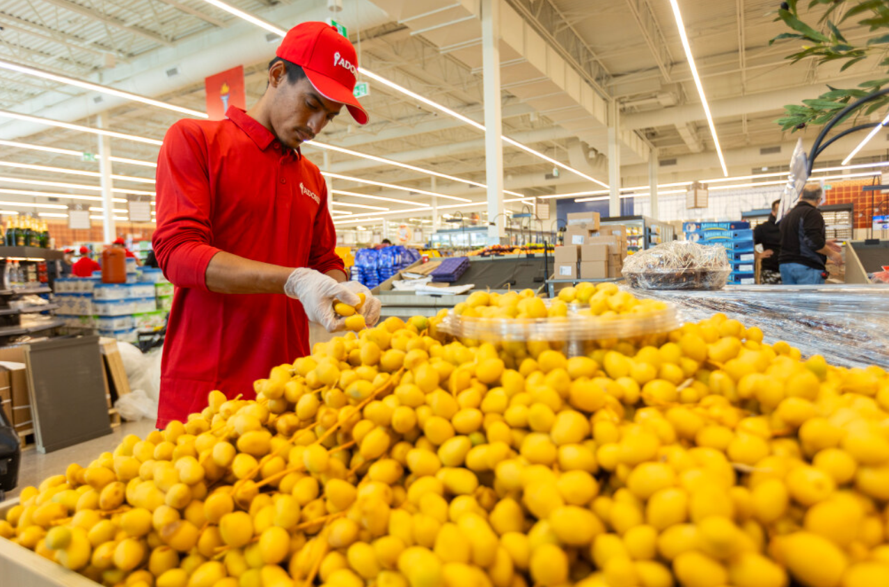 Ahmad El-Hamad lays out dates on a display at Adonis, a Mediterranean grocery store set to open within days. Photo taken in London on Aug. 12, 2025. Mike Hensen /The London Free Press
