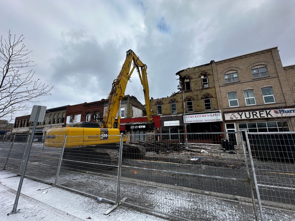 Demolition of a downtown St. Thomas building began Friday, a day after the structure was severely damaged by a fire.