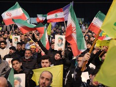 Hezbollah supporters wave Iranian and Lebanese flags