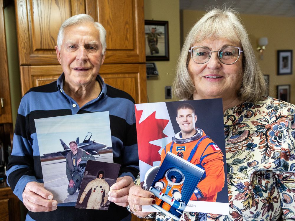  Gary and Nancy Hansen of Ingersoll hold photos of their son, Jeremy Hansen. The smaller images show Jeremy at age six in a space suit and at age 11 in another suit during family trips to Florida. (Mike Hensen/The London Free Press)