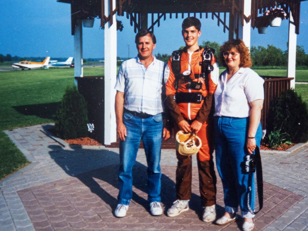  Jeremy Hansen at the age of 15 after his first skydive, with his parents Gary and Nancy. Photograph handout by Gary and Nancy Hansen.