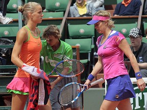 Belgium's Kim Clijsters (R) passes by Netherland's Arantxa Rus during their Women's second round match in the French Open tennis championship at the Roland Garros stadium, on May 26, 2011, in Paris.  AFP PHOTO / JACQUES DEMARTHON (Photo credit should read JACQUES DEMARTHON/AFP/Getty Images)