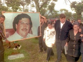 MEDELLIN, COLOMBIA - DECEMBER 2:  Hermilda de Escobar (2nd-R), mother of Medellin drug cartel kingpin Pablo Escobar (portrait), walks with friends and relatives to Escobar's tomb to celebrate the first anniversary of his death. Escobar was killed by Colombian special forces after being discovered hiding in a house in Medellin. (GUILLERMO TAPIA/AFP/Getty