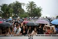 People wait under heavy rain before the screening of "Pirates of the Caribbean : On Stranger Tides" on May 14, 2011 in Cannes. (ANNE-CHRISTINE POUJOULAT/AFP/Getty Images)