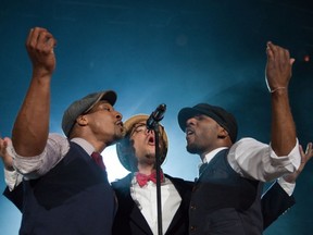 Ben L'Oncle Soul, flanked by two of his dancers and backup singers at the Montreal International Jazz Festival's opening-night Big Event; taken July 25, 2011, by Dave Sidaway/ The Gazette