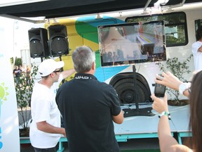 A girl plays Croc En Bus, the interactive game designed by Montreal startup 2XM for the STM.