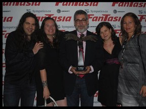 Photo taken July 27, 2011 at Fatasia Film Festival in Montreal shows (from left) Mitch Davis, Angie Burns, American writer-director John Landis with his award, Stephanie Trepanier of Evokative films (she's  a programmer and hospitality director, too. The woman in grey is not identified.
Photo by Fantasia programmer King Wei-Chu.