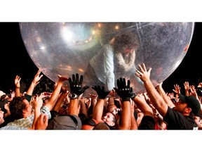 The Flaming Lips lead singer Wayne Coyne performs at the Osheaga Music and Arts Festival in Montreal, July 31, 2011