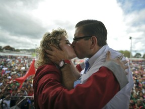 Guatemalan presidential candidate for the Renewed Democratic Liberty party (LIDER), Manuel Baldizon (R), kisses his wife, Rosa Vargas, during the closing of his campaign, at Alameda neighborhood in Guatemala City, on November 4, 2011. Baldizon and retired General Otto Perez Molina are going for a run-off election on November 6 in Guatemala. AFP PHOTO/Johan ORDONEZ (Photo credit should read JOHAN ORDONEZ/AFP/Getty Images)