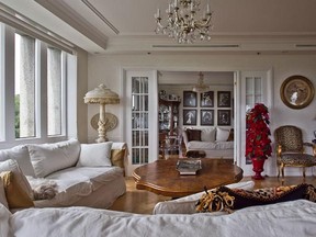 MONTREAL, QUE: JULY 27, 2011 - Really nice photo, I think. The perspective shows the two couches at Jennifer Cukier's Fort de la Montagne condo, slipcovered in white fabric for a clean and light effect -- the upholstery, pale gold velvet, trimmed in fringe, make san appearance in the cooler weather, when the slipcovers come off. Also visible is the oval coffee table and, in the corner, the marble floor lamp mentioned in the story, and the oval wall plaque from HomeSense. Also gives you some idea of space. and there is Newton on the counch. Montreal on Wednesday, July 27, 2011 for the Urban Expressions magazine. (Dave Sidaway / THE GAZETTE)