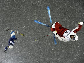 MERIBEL, FRANCE - DECEMBER 20: (FRANCE OUT) Denis Dolgodorov of Russia and Mikael Kingsbury of Canada compete during the FIS Freestyle Ski World Cup Dual Moguls on December 20, 2011 in Meribel, France. (Photo by Alain Grosclaude/Agence Zoom/Getty Images)