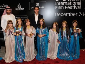 Actor Tom Cruise at the Mission: Impossible - Ghost Protocol premiere at the Dubai International Film Festival, December 7, 2011 in Dubai, United Arab Emirates.  Are those little girls cute, or what? (Gareth Cattermole/Getty Images for DIFF)