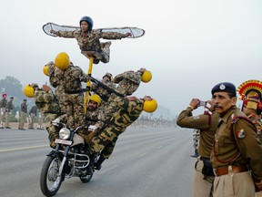 NEW DELHI, INDIA - JANUARY 11:  Indian soldiers practice their stunts on Royal Enfield motorcycles in preparation for the upcoming Republic Day parade on January 11, 2012 in New Delhi, India. Republic Day is celebrated every year on January 26 to commemorate the date and moment when the Constitution of India came into effect. A grand parade marks the day in the capital, with a show of force by the Indian military that starts from the Raisina Hill in the neighborhood of the majestic Rashtrapati Bhawan that passes along the Rajpath and ends at India Gate. (Photo by Daniel Berehulak /Getty Images)