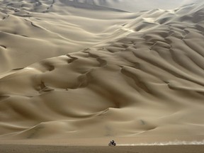 A lonesome motorcyclist rides across the desert during the stage 11 of the Dakar 2012, between Arica and Arequipa, Chile, on January 12, 2012. French Cyril Despres won stage 11.  (PHILIPPE DESMAZES/AFP/Getty Images)