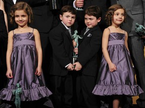 Actors from TV show Boardwalk Empire hold their  award for best ensemble in a drama series in the press room at the 18th Annual Screen Actors Guild Awards at the Shrine Auditorium in Los Angeles, California on January 29, 2012. The twin girls are Lucy and Josie Gallina  and the twin boys are Brady and Connor Noon. The boys seem to have quite a tight grip on the award, don't they? As if they're both thinking, "Let go! It's MINE!"
(FREDERIC J. BROWN/AFP/Getty Images)