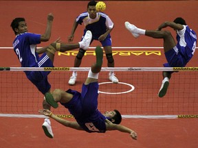 PALEMBANG, SUMATRA, INDONESIA - FEBRUARY 25:  Thailand's Kaokaew Pornchai reutrns a shot to Indonesia in the men's semi-final during day three of the ISTAF Super Series at the Palembang Sport Convention Center on February 25, 2012 in Palembang, Sumatra, Indonesia.  (Photo by Nicky Loh/Getty Images for UFA Sports)