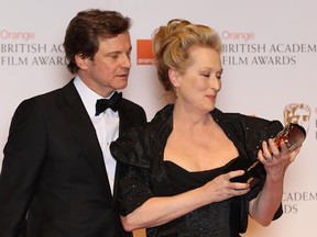 Actress Meryl Streep shows Colin Firth the Best Actress BAFTA award she won for playing Margaret Thatcher in the movie The Iron Lady. (Photo by Chris Jackson/Getty Images)