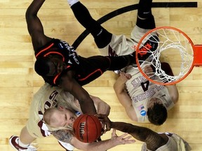NASHVILLE, TN - MARCH 18:  Deividas Dulkys #4 of the Florida State Seminoles falls to the floor as Cheikh Mbodj #13 of the Cincinnati Bearcats trips over him during the third round of the 2012 NCAA Men's Basketball Tournament at Bridgestone Arena on March 18, 2012 in Nashville, Tennessee.  (Photo by Kevin C. Cox/Getty Images)