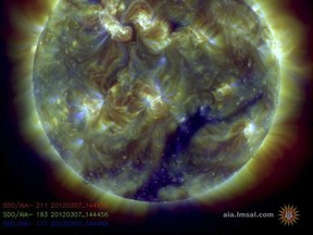 This handout image provided by  NASA on March 7, 2012, shows a color-coded image combines observations made by NASA's Solar Dynamics Observatory in several extreme ultraviolet wavelengths, highlighting a bright X-class flare toward the upper left of the sun's disk on March 6. This flare was categorized as an X5.4, making it the second largest flare -- after an X6.9 on August 9, 2011. A pair of steamy explosions on the Sun's surface in recent days is sparking the biggest radiation and geomagnetic storm the Earth has experienced in five years, space weather experts said March 7. The full brunt of the storm is expected to hit Earth early Thursday US time and last through Friday, potentially disrupting power grids, GPS systems, satellites, and forcing airplanes to change their routes around the polar regions.   (NASA via /AFP/Getty Images)