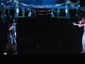 INDIO, CA - APRIL 15:  Rapper Snoop Dogg (L) and a hologram of deceased Tupac Shakur perform onstage during day 3 of the 2012 Coachella Valley Music & Arts Festival at the Empire Polo Field on April 15, 2012 in Indio, California.  (Photo by Christopher Polk/Getty Images for Coachella)