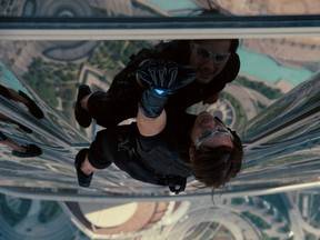 Tom Cruise and Tom Cruise's scowling reflection in Mission Impossible: Ghost Protocol