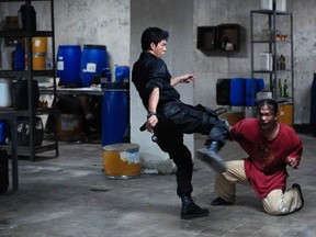 Policeman Rama (Iko Uwais) administers a kick to criminal Mad Dog (Yayan Ruhian). Mad Dog might be down but he is far from out.