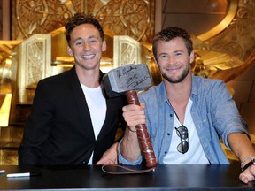 Actors Tom Hiddleston (left), and Chris Hemsworth with Thor's magical hammer at Comic-Con 2010 on July 24, 2010 in San Diego, California.  (Photo by Frazer Harrison/Getty Images)